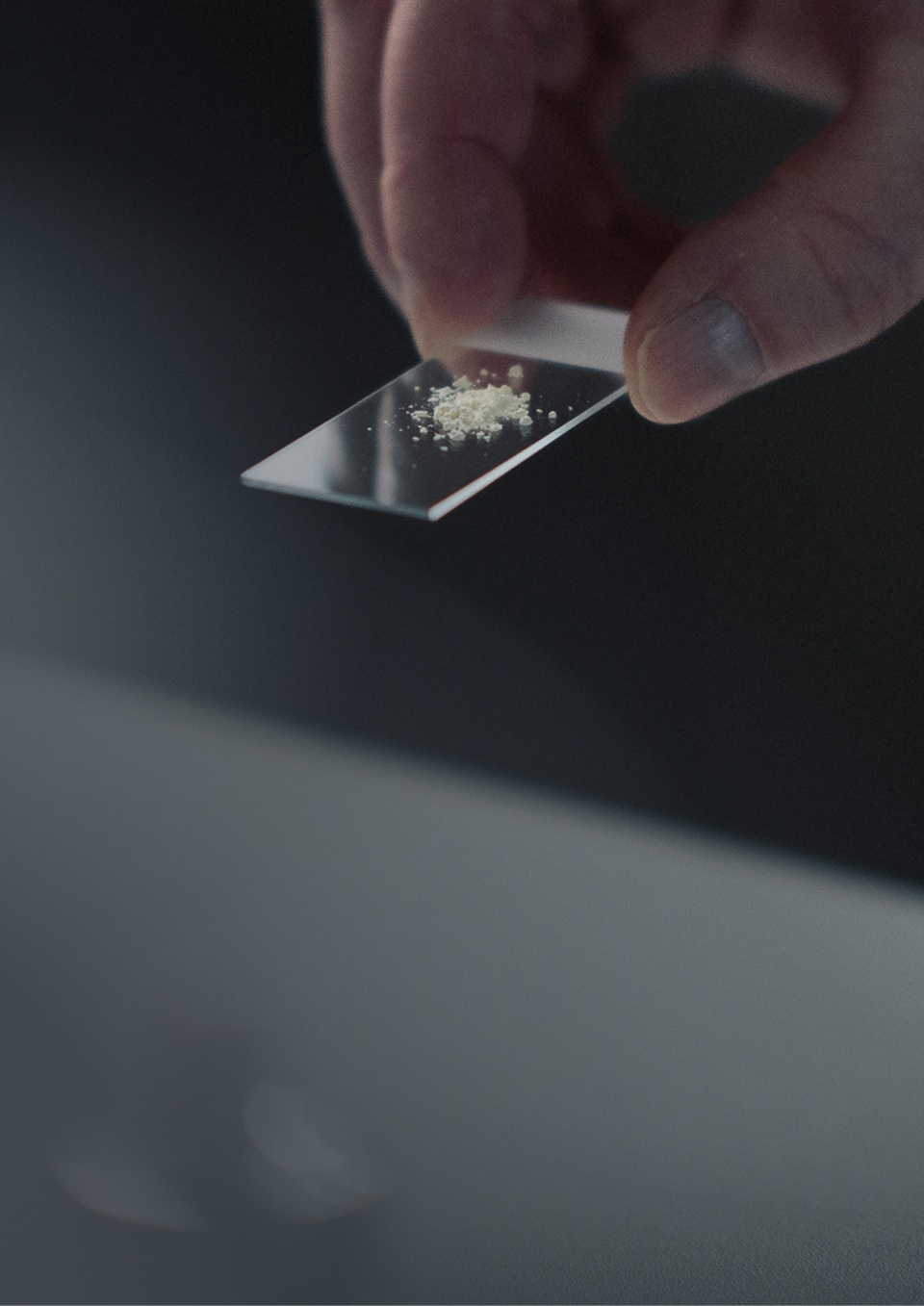 A hand preparing a measured dose of Mitopure